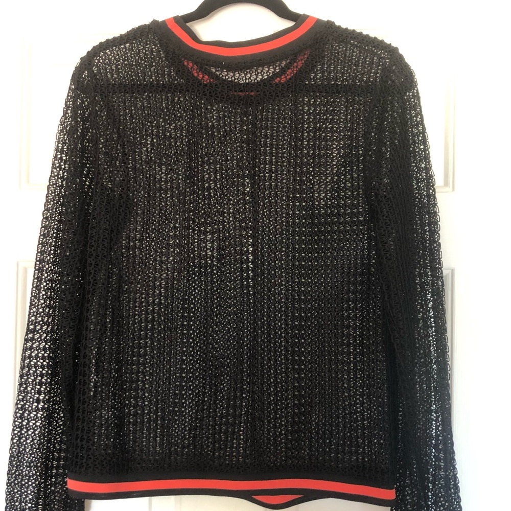 Black mesh top with orange collar.